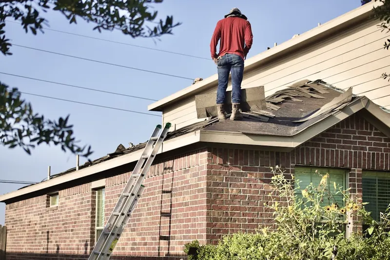 Professional roofer working on a residential roof in Creekwood Estates